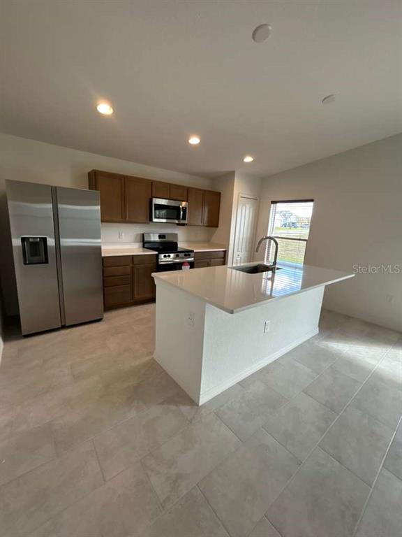 2203 Carson Loop Lake Lake Wales, FL 33859 - Photo 5 of 14 a kitchen with refrigerator and furniture