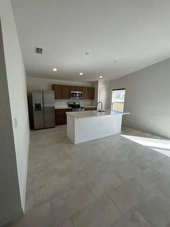 a view of a kitchen with a sink and a refrigerator