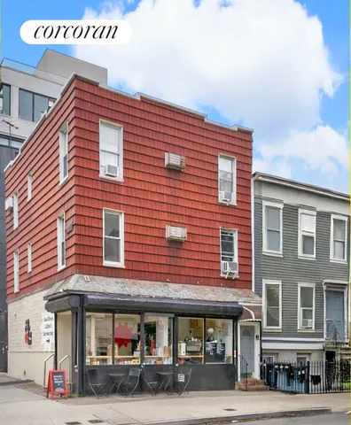 a building with potted plants and seating space