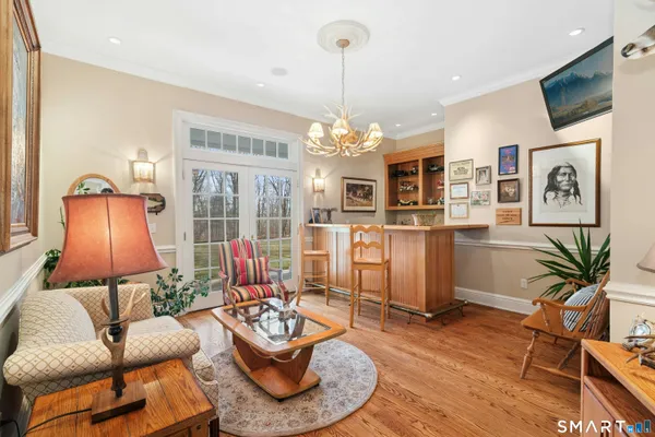 a living room with furniture kitchen and a chandelier