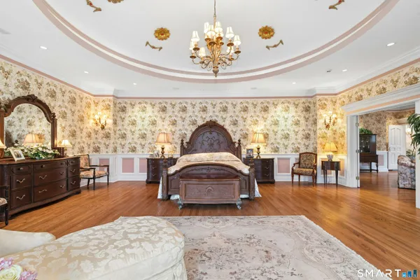 a bedroom with a large bed and a large window