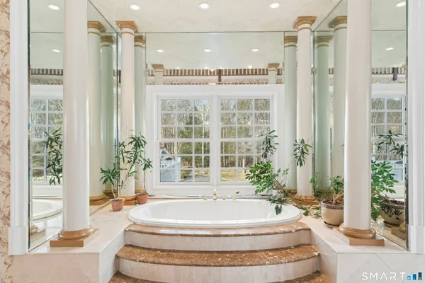 a bedroom with a bed and a book shelf