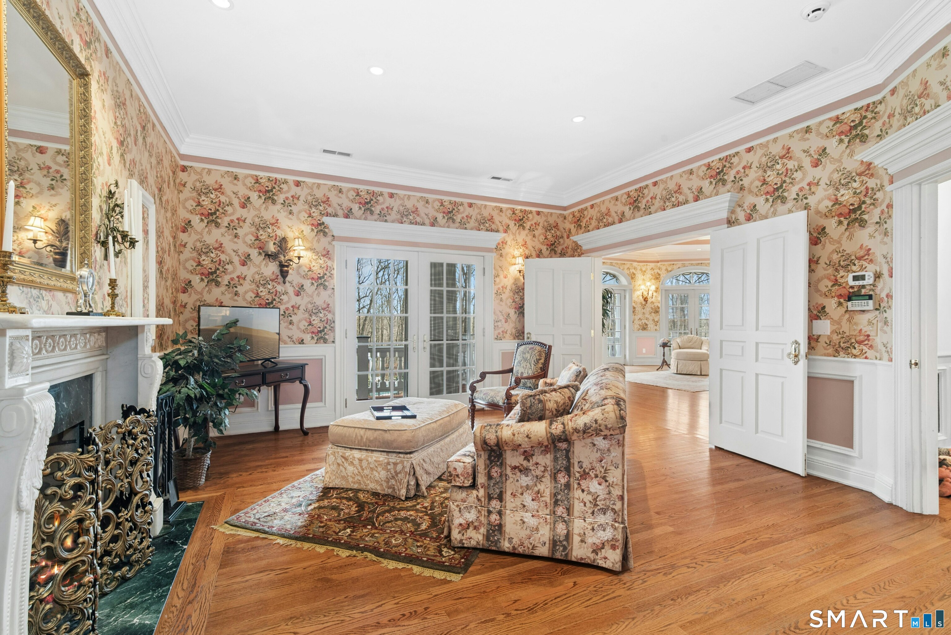 63 Turney Road Redding, CT 06896 - Photo 30 of 40 Primary Sitting Room. Cozy with fireplace and French doors open to the exterior balcony