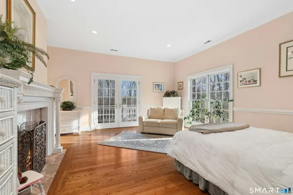 a living room with furniture a wooden floor and a fireplace