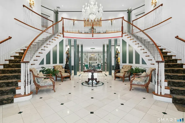 a living room with patio furniture and a chandelier