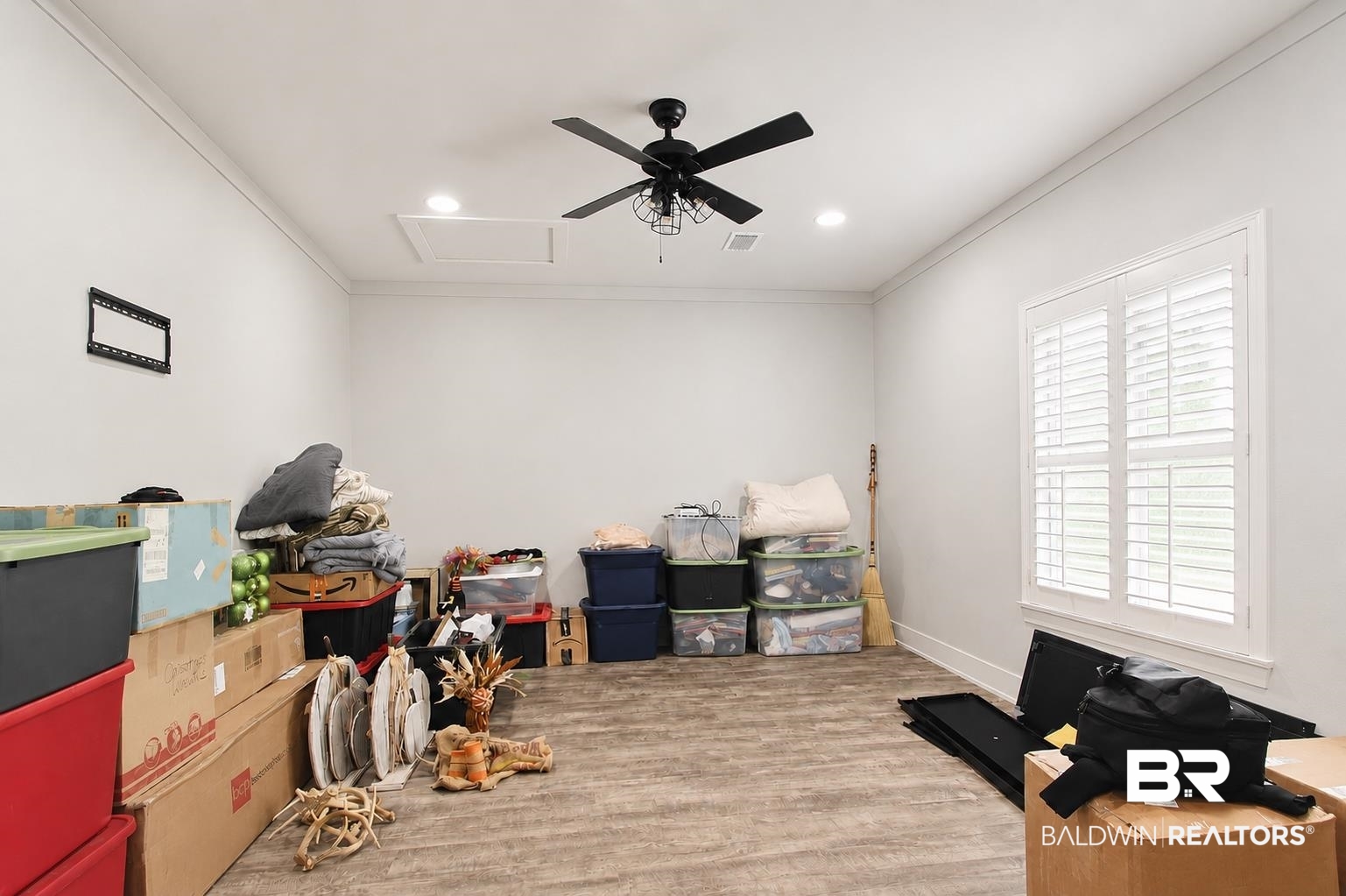 9825 Wolf Creek Ridge Elberta, AL 36530 - Photo 15 of 76 Spacious room featuring wood-finish flooring, white walls, and a ceiling fan with integrated lighting
