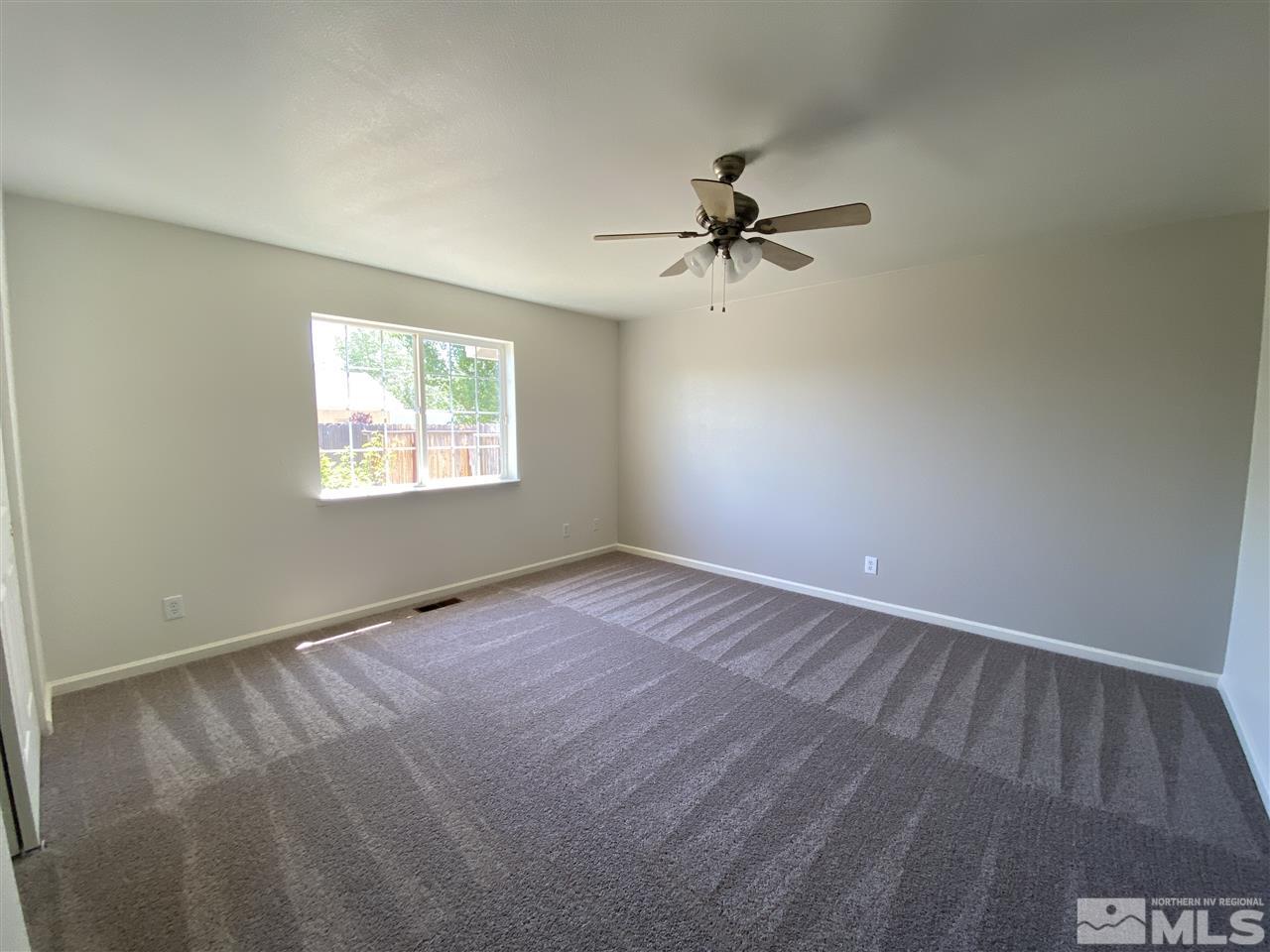 1200 Lattin Road Fallon, NV 89406 - Photo 12 of 19 an empty room with windows and fan