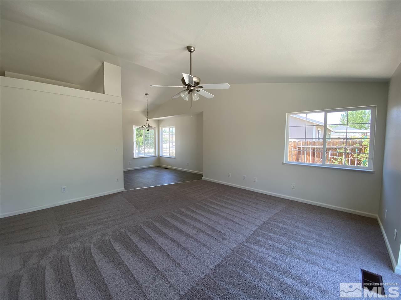 1200 Lattin Road Fallon, NV 89406 - Photo 3 of 19 an empty room with wooden floor and windows