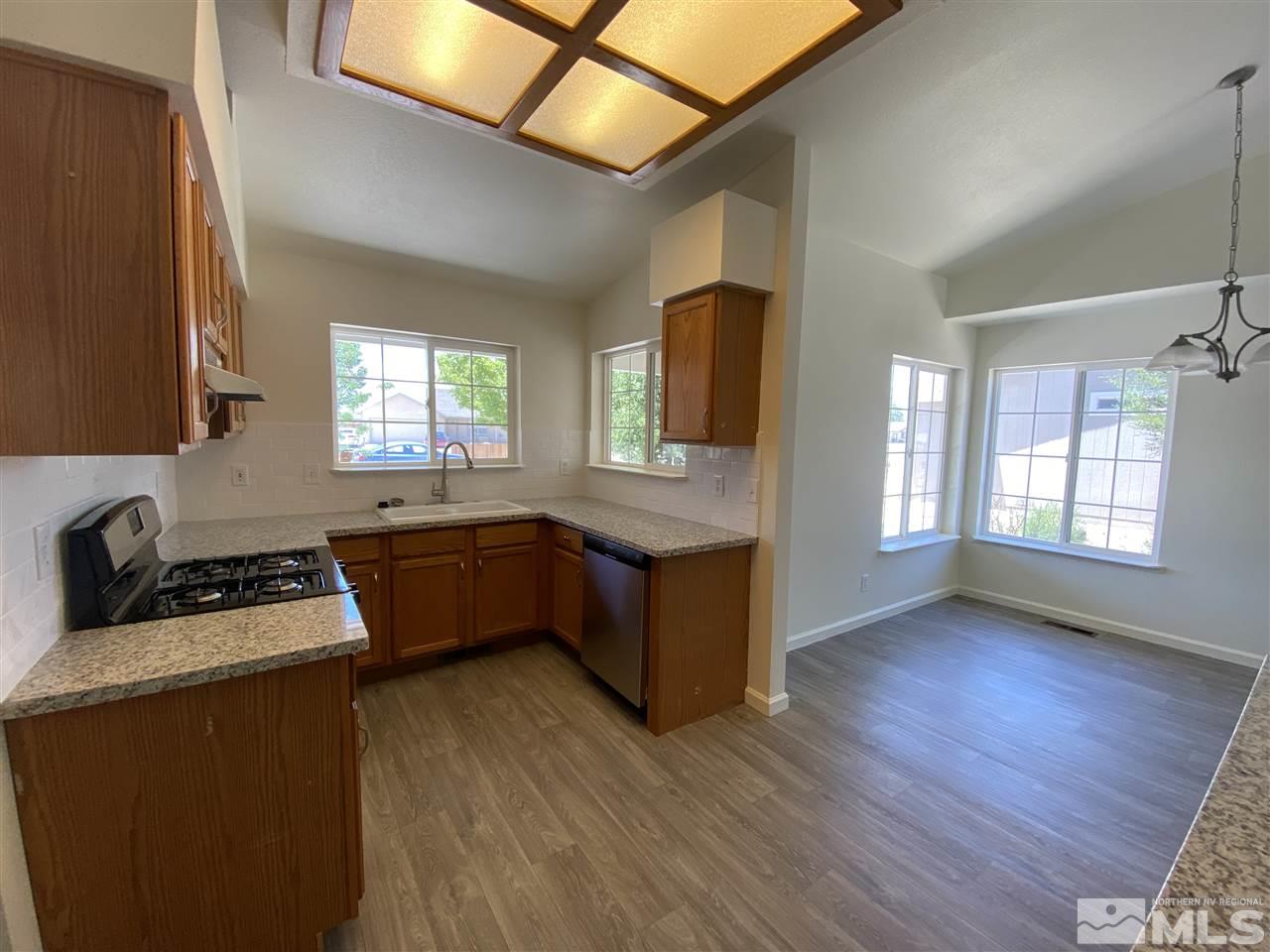 1200 Lattin Road Fallon, NV 89406 - Photo 4 of 19 a kitchen with wooden floors and sink