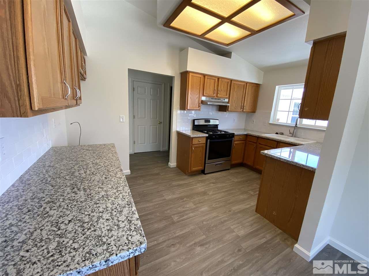 1200 Lattin Road Fallon, NV 89406 - Photo 5 of 19 a kitchen with stainless steel appliances granite countertop a sink stove and refrigerator