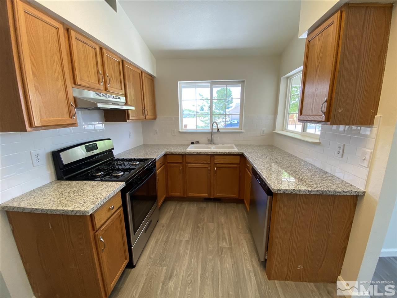 1200 Lattin Road Fallon, NV 89406 - Photo 6 of 19 a kitchen with a sink stove top oven and cabinets