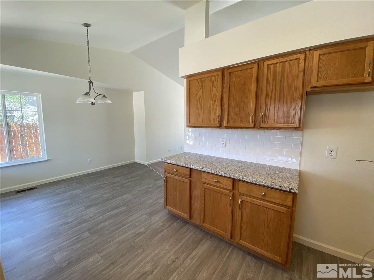 1200 Lattin Road Fallon, NV 89406 - Photo 7 of 19 a kitchen with stainless steel appliances granite countertop wooden cabinets a oven and a sink with wooden floor