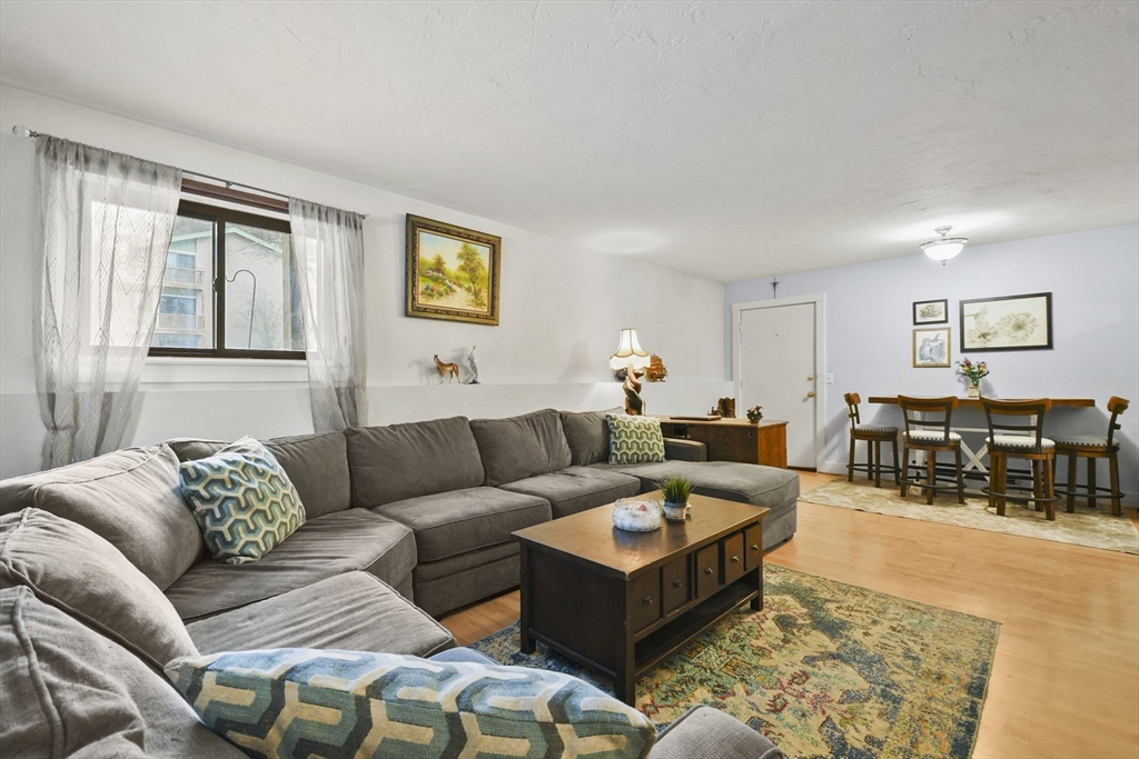 976 Plain Street, Unit 48 Marshfield, MA 02050 - Photo 11 of 20 a living room with furniture and wooden floor
