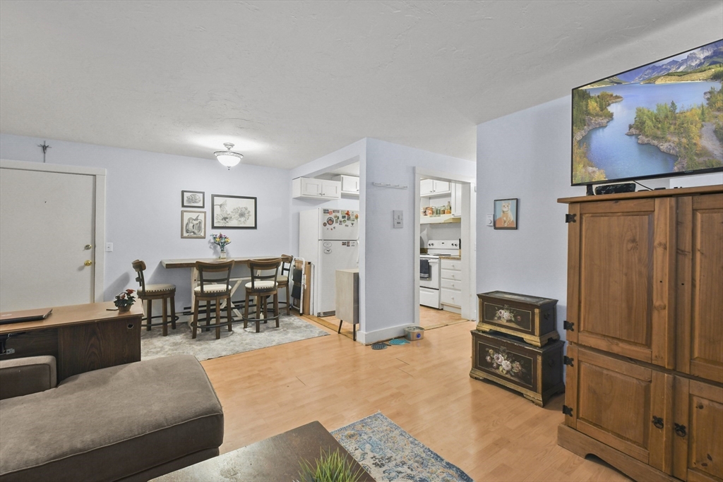 976 Plain Street, Unit 48 Marshfield, MA 02050 - Photo 12 of 20 a living room with furniture a refrigerator and a stove