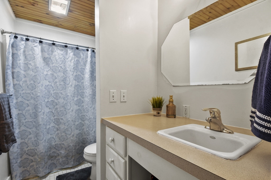 976 Plain Street, Unit 48 Marshfield, MA 02050 - Photo 14 of 20 a bathroom with a sink and a mirror