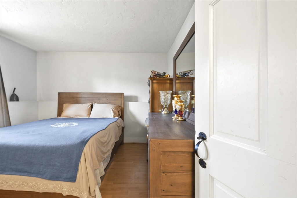 976 Plain Street, Unit 48 Marshfield, MA 02050 - Photo 15 of 20 a bedroom with a bed and a table