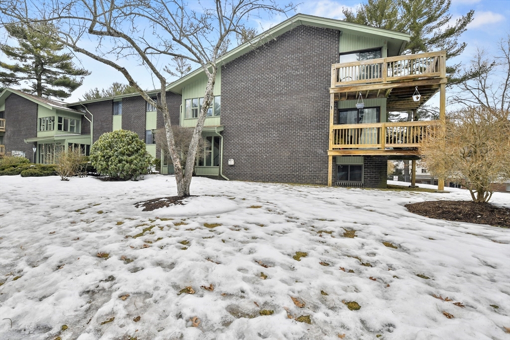 976 Plain Street, Unit 48 Marshfield, MA 02050 - Photo 20 of 20 a front view of a house with a yard and garage