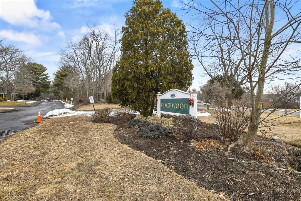 976 Plain Street, Unit 48 Marshfield, MA 02050 - Photo 2 of 20 a view of a yard with snow on the road