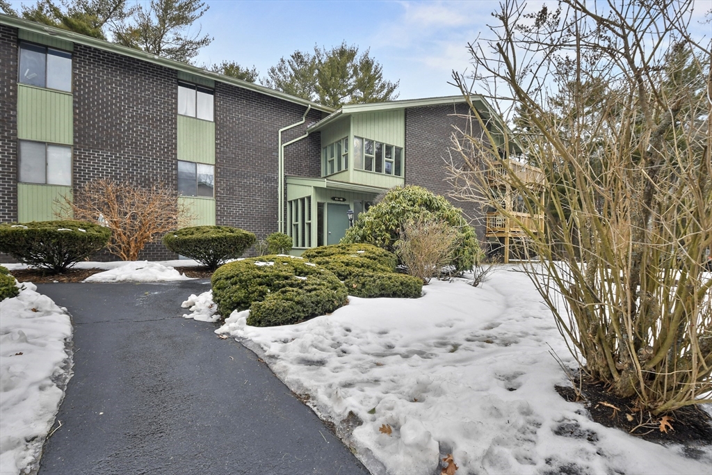976 Plain Street, Unit 48 Marshfield, MA 02050 - Photo 3 of 20 a front view of a house with a yard and garage