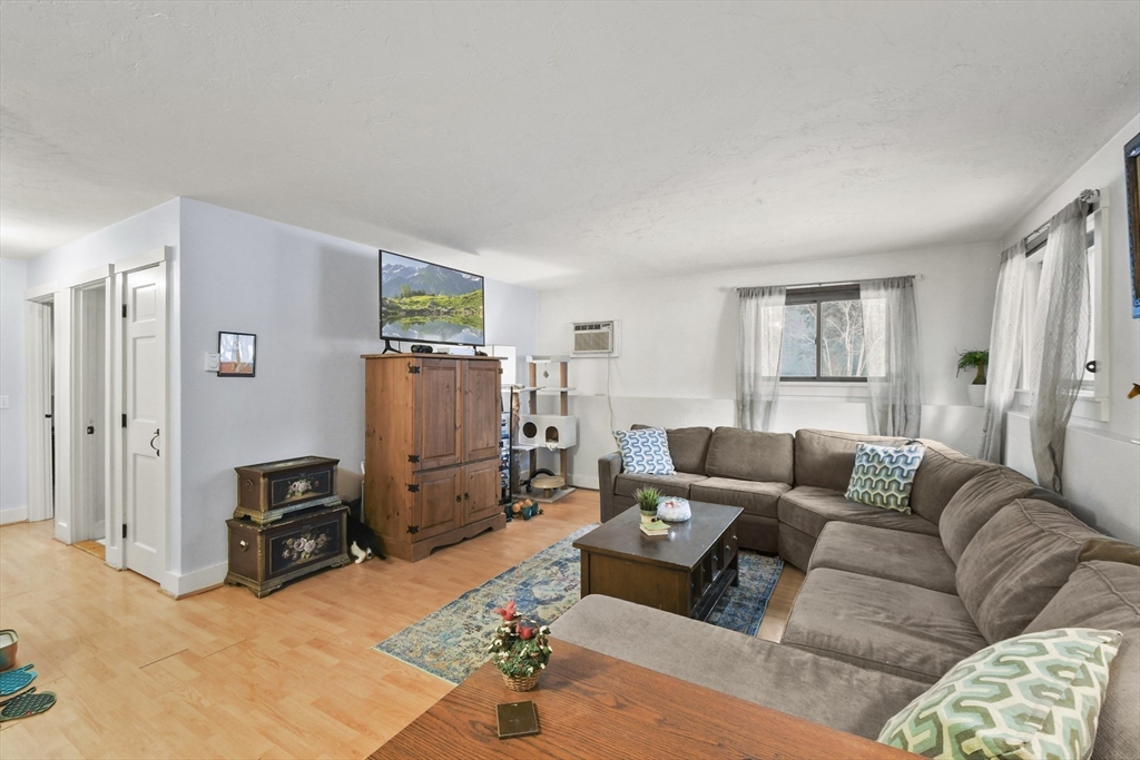 976 Plain Street, Unit 48 Marshfield, MA 02050 - Photo 9 of 20 a living room with furniture and a flat screen tv