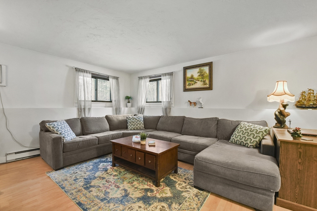976 Plain Street, Unit 48 Marshfield, MA 02050 - Photo 10 of 20 a living room with furniture and a couch