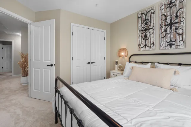 a bedroom with a large bed and a shower