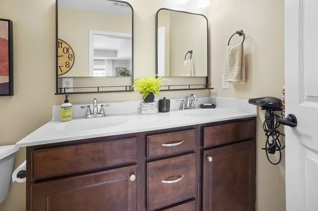 a bathroom with a double vanity sink and a mirror
