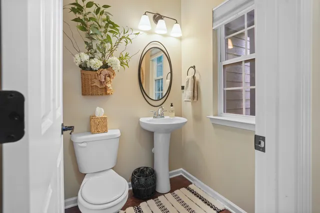 a bathroom with a toilet a sink and a mirror