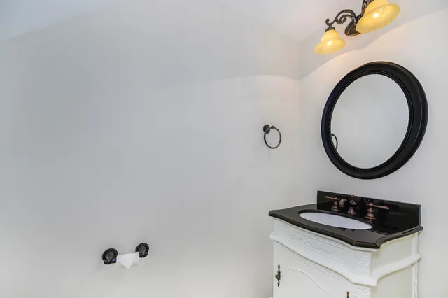 a bathroom with a sink a mirror and a shower