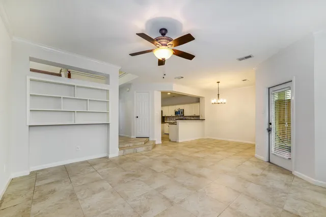 a view of a kitchen with a sink and a ceiling fan