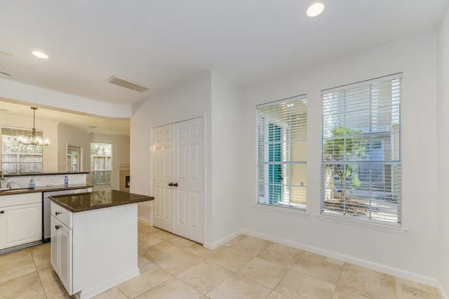 a kitchen with granite countertop sink and cabinets