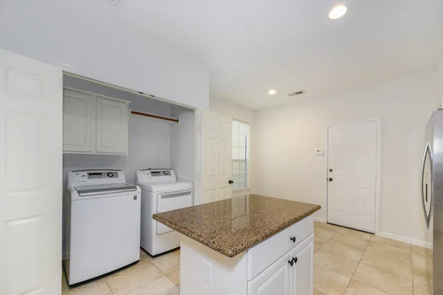 a kitchen that has a sink a stove and a refrigerator