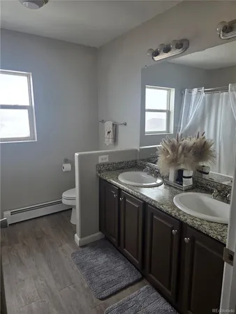 a bathroom with double sink and a mirror