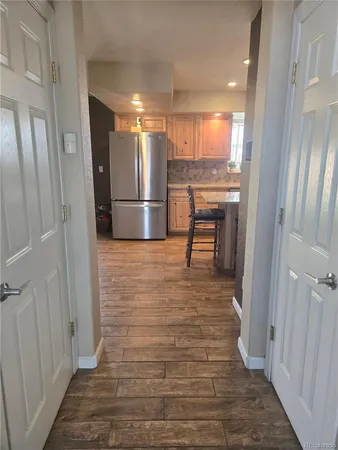a view of kitchen with furniture and refrigerator
