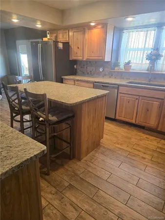 a kitchen with kitchen island a sink table and chairs