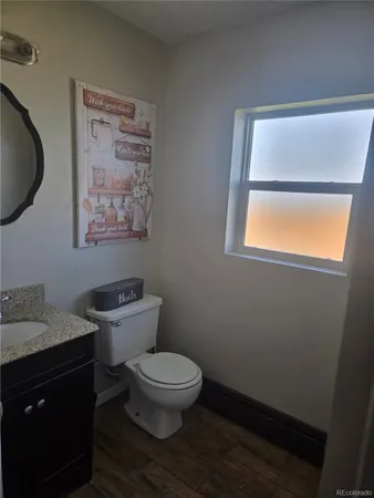 a white toilet sitting next to a bathroom sink