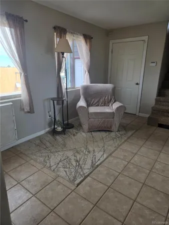 a view of a room with white walls and stairs