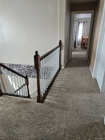 a view of a hallway view with staircase