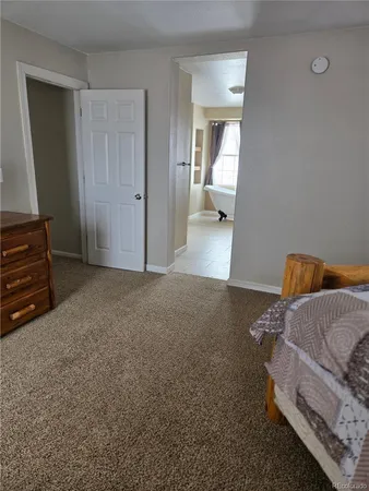 a living room with furniture and a mirror