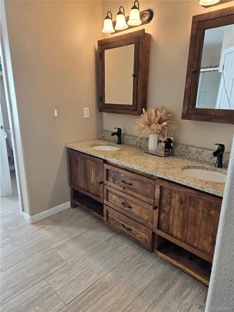 a bathroom with a double vanity sink and mirror