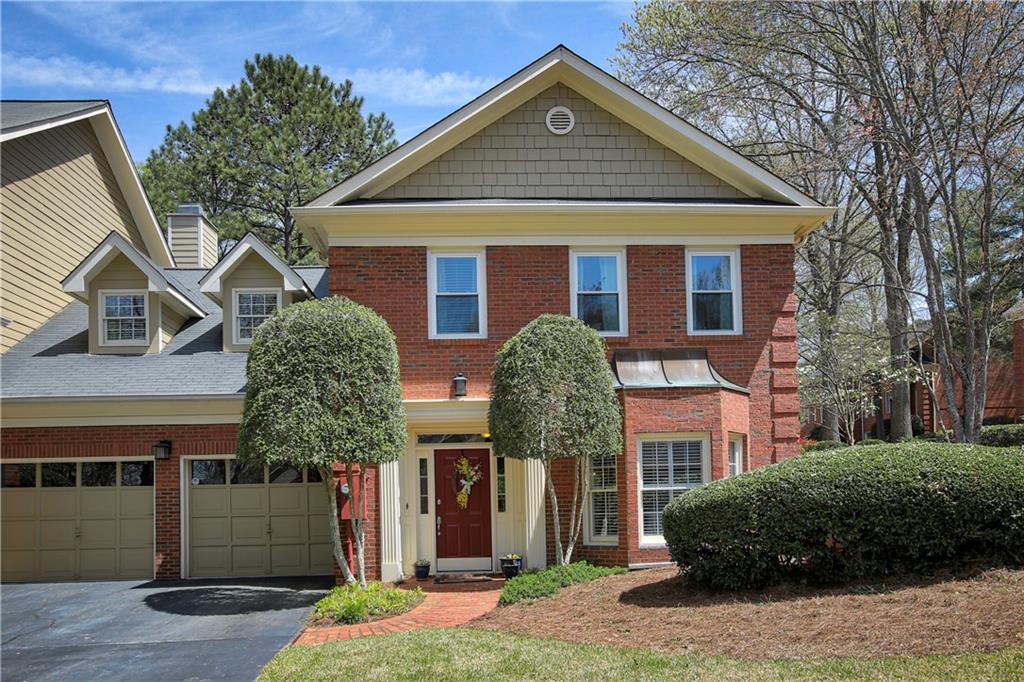7155 Roswell Road, Unit 43 Sandy Springs, GA 30328 - Photo 1 of 1 a front view of a house with garden