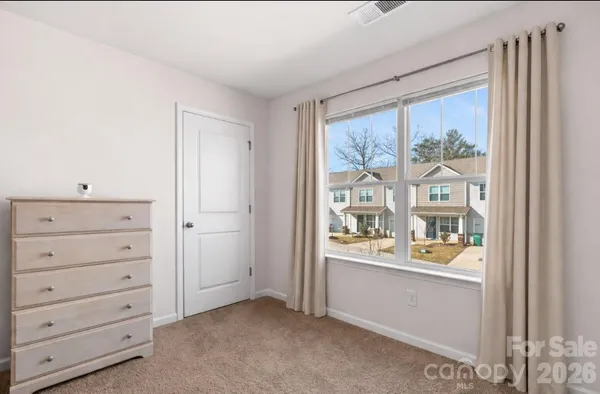 a room with a dresser and a window