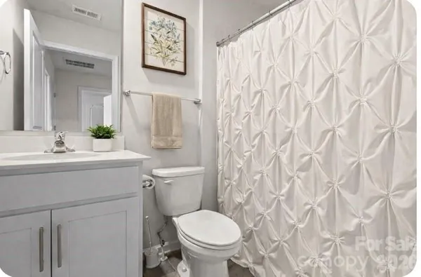 a bathroom with a toilet sink and a mirror
