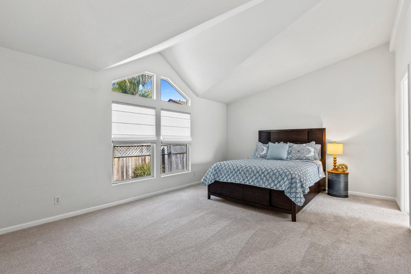 2155 Wharf Road, Unit 9 Capitola, CA 95010 - Photo 15 of 27 a spacious bedroom with a bed and a window
