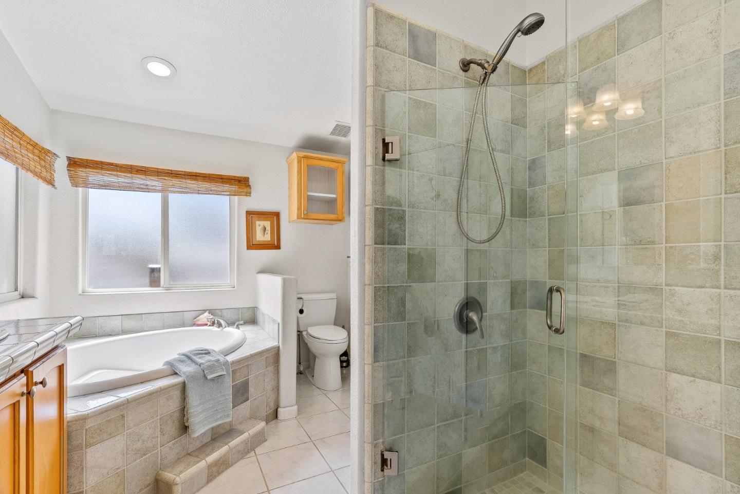 2155 Wharf Road, Unit 9 Capitola, CA 95010 - Photo 19 of 27 a bathroom with a bathtub shower sink vanity and toilet