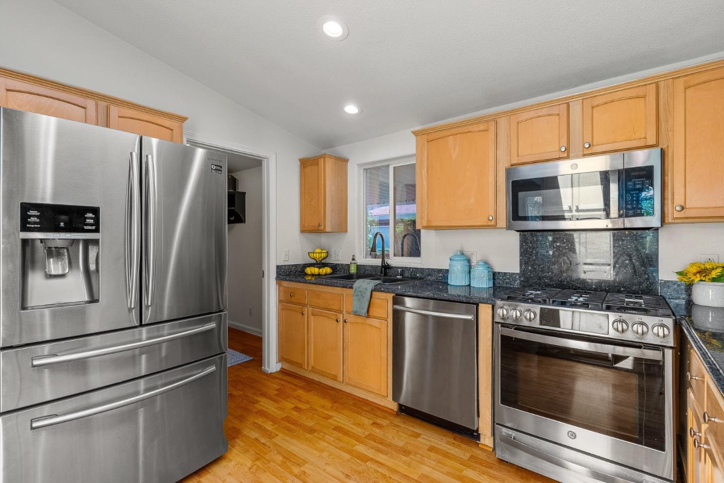 2155 Wharf Road, Unit 9 Capitola, CA 95010 - Photo 10 of 27 a kitchen with stainless steel appliances granite countertop a refrigerator stove and microwave