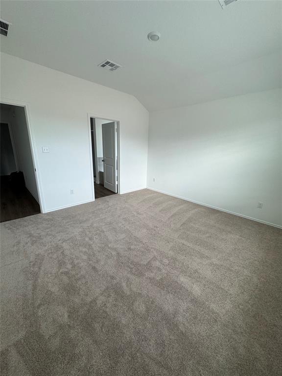 216 Jeffers Kyle, TX 78640 - Photo 14 of 19 Spacious room featuring plush, neutral-toned carpeting, crisp white walls, and a recessed ceiling light
