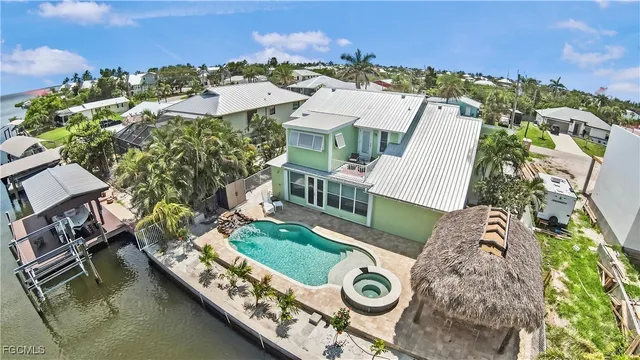 an aerial view of a house with a ocean view