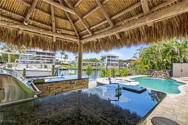 a kitchen with stainless steel appliances granite countertop a sink and a stove