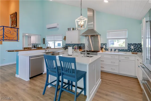 a kitchen with a dining table cabinets appliances and a window
